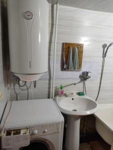 y baño con lavabo y lavadora. en Абхазия Дом Под Ключ Алахадзы en Alakhadzi