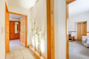 a living room with a door open to a room at Distyll in Ruthin