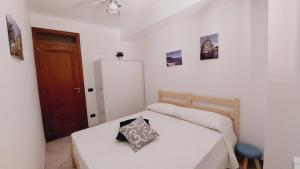 a small bedroom with a bed and a refrigerator at A me Casa in Gioiosa Marea