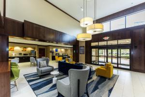 a lobby of a hospital with chairs and tables at Comfort Suites Houston West at Clay Road in Houston