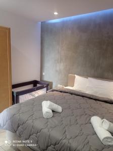 a bedroom with a large bed with towels on it at Havania studio in Agios Nikolaos