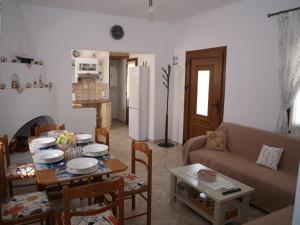 a kitchen and living room with a table and a couch at ilioni house in Skopelos Town