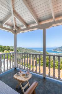 a porch with a table and a view of the ocean at Liagka Villa in Skopelos Town