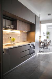 a kitchen with a sink and a table in it at Allure Apartments in Ulcinj