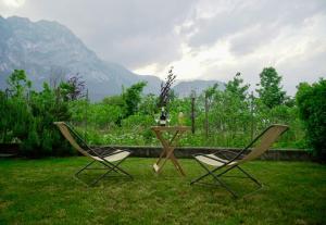 two chairs and a table in the grass at Lake & rest in Riva del Garda