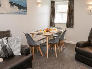 a dining room with a table and chairs at Razorbill Cottage in Whitby
