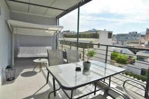 a balcony with a table and chairs on a balcony at Feel Athens Studios at Monastiraki in Athens