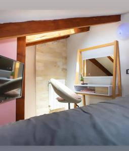 a bedroom with a mirror and a chair and a bed at Apartment "Istra Inspirita" in Rovinj