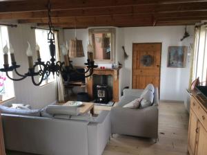 a living room with two couches and a table at Dijkhuisje Zeeland in Waterlandkerkje