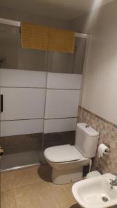 a bathroom with a toilet and a sink at HABITACIONES EN frente DEL PUERTO in Almería +18 photos