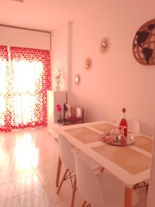 a dining room with a white table and white chairs at Gamonal n.4 in Benalmádena