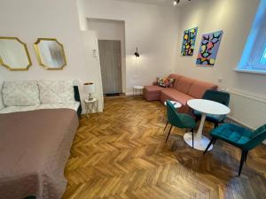 a living room with a couch and a table at Willa 1936 , Parking in Toruń