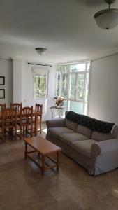 a living room with a couch and a table at HABITACIONES EN frente DEL PUERTO in Almería