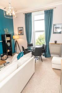 a living room with a white couch and a table at * POPULAR * Stunning quiet apartment by the sea in Torquay