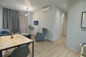 a living room with a table and chairs at Feel Athens Studios at Monastiraki in Athens
