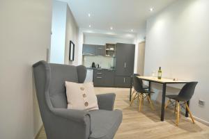 a living room with a table and a chair at Feel Athens Studios at Monastiraki in Athens
