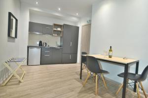a kitchen and dining room with a table and chairs at Feel Athens Studios at Monastiraki in Athens