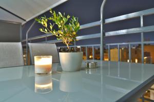 a table with a candle and a potted plant on it at Feel Athens Studios at Monastiraki in Athens