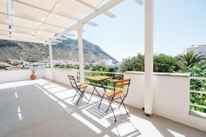 a balcony with chairs and a table with a view at Oasis in Kamarai