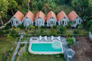 an aerial view of a resort with a swimming pool at Kayu Kuning Cottage in Nusa Penida
