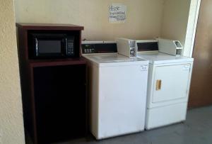 a kitchen with a microwave and a small refrigerator at Metro Inn & Suites in Jacksonville