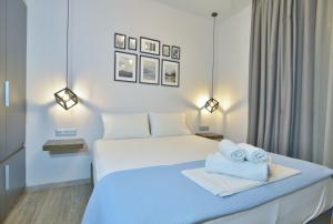 a bedroom with a bed with towels on it at Feel Athens Studios at Monastiraki in Athens
