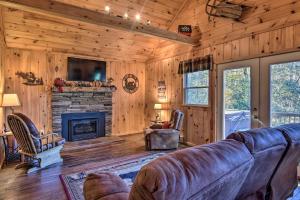a living room with a couch and a fireplace at Natures Retreat with Hot Tub 7 Mi to Bryson City in Whittier