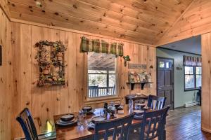 a wooden dining room with a table and chairs at Natures Retreat with Hot Tub 7 Mi to Bryson City in Whittier