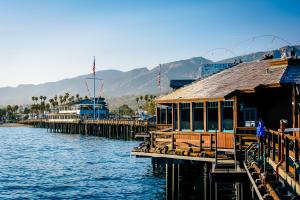 a marina with a pier and buildings on the water at East Beach Retreats in Santa Barbara
