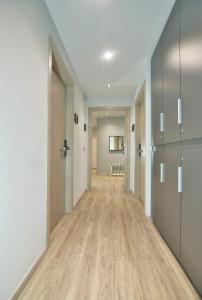 an empty hallway with wood floors and a door at Feel Athens Studios at Monastiraki in Athens