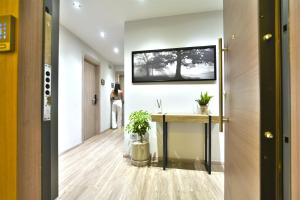 a hallway with a table and a picture on the wall at Feel Athens Studios at Monastiraki in Athens