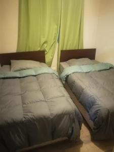 Säng eller sängar i ett rum på Departamento Hospedaje Rancagua Centro