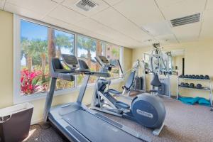 a gym with cardio machines and a window at The Islander 412 in Destin
