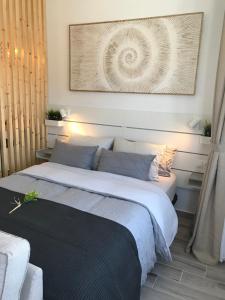 a bedroom with a bed with a picture on the wall at Arena Negra in Tarajalejo