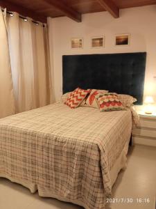 a bedroom with a bed with two pillows on it at Solar Flats - WooD - Pipa RN in Pipa