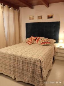 a bedroom with a bed with two pillows on it at Solar Flats - WooD - Pipa RN in Pipa +9 photos
