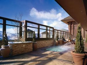 a house with a swimming pool with mountains in the background at Ameristar Casino Black Hawk in Black Hawk