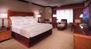 a hotel room with a bed and a flat screen tv at Ameristar Casino Black Hawk in Black Hawk +17 photos