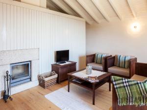 a living room with a couch and a fireplace at Traços D'Outrora in Vale de Cambra