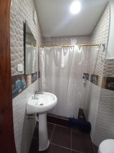 a bathroom with a sink and a shower at Hostería La Chorrera in Quito