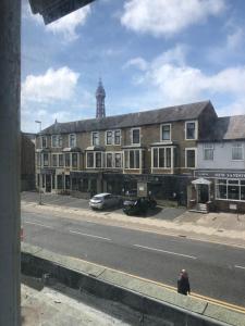 a person sitting on the side of a street at Sky city hotel in Blackpool