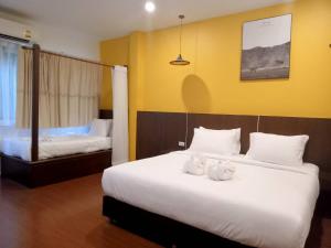 a hotel room with two beds with towels on them at Blue Orchid Beach Krabi - SHA Certified in Ao Nam Mao