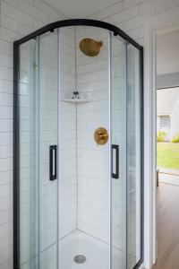 a shower with a glass enclosure in a bathroom at Inn on the Beach in Harwich Port