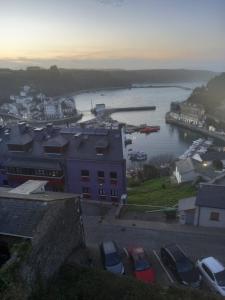 a view of a harbor with cars parked next to the water at LUARCAPLAYA APARTAMENTO Plazas de garaje incluidas in Luarca