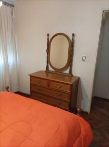 a bedroom with a dresser with a mirror on it at Hermoso departamento en Mendoza in Mendoza