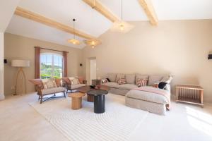 a living room with a couch and a table at SERRENDY Villa with infinity swimming pool in Roquefort-les-Pins