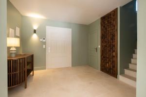 a hallway with a white door and a staircase at SERRENDY Villa with infinity swimming pool in Roquefort-les-Pins