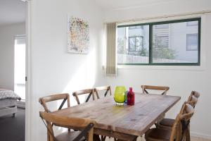 a wooden table with a yellow vase on it at Questa E Bella in Lorne +10 photos