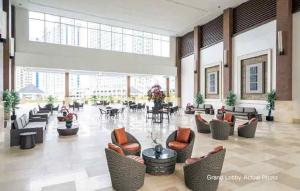a large lobby with couches and tables in a building at Wind Residence Designer Appt overlooking Taal lake - Tower 1 - 42sqm in Tagaytay