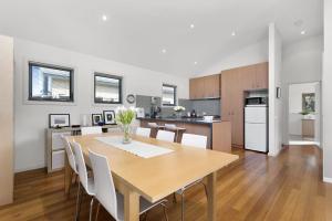 a kitchen and dining room with a table and chairs at Cape Vista 3 in Apollo Bay